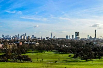 Panoramic view of city against cloudy sky