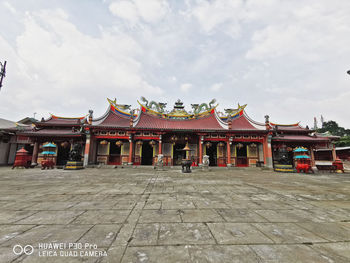 View of temple building against cloudy sky