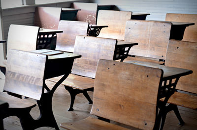 Empty wooden benches in classroom at school