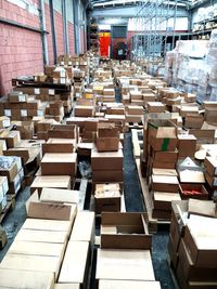 High angle view of cardboard boxes on pallets in factory
