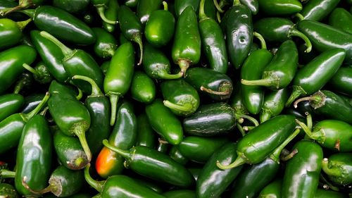 Full frame shot of green chili peppers at market stall