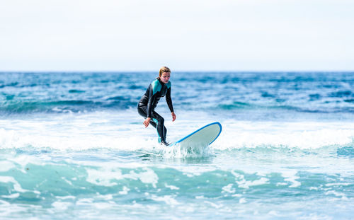 Full length of man in sea against sky