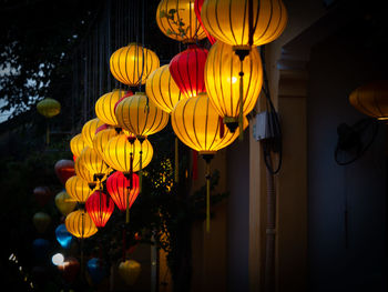 Low angle view of illuminated lanterns hanging at night