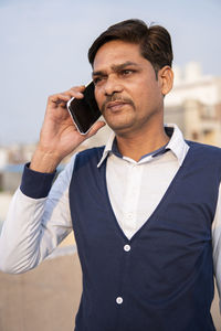 Mid adult man using smart phone