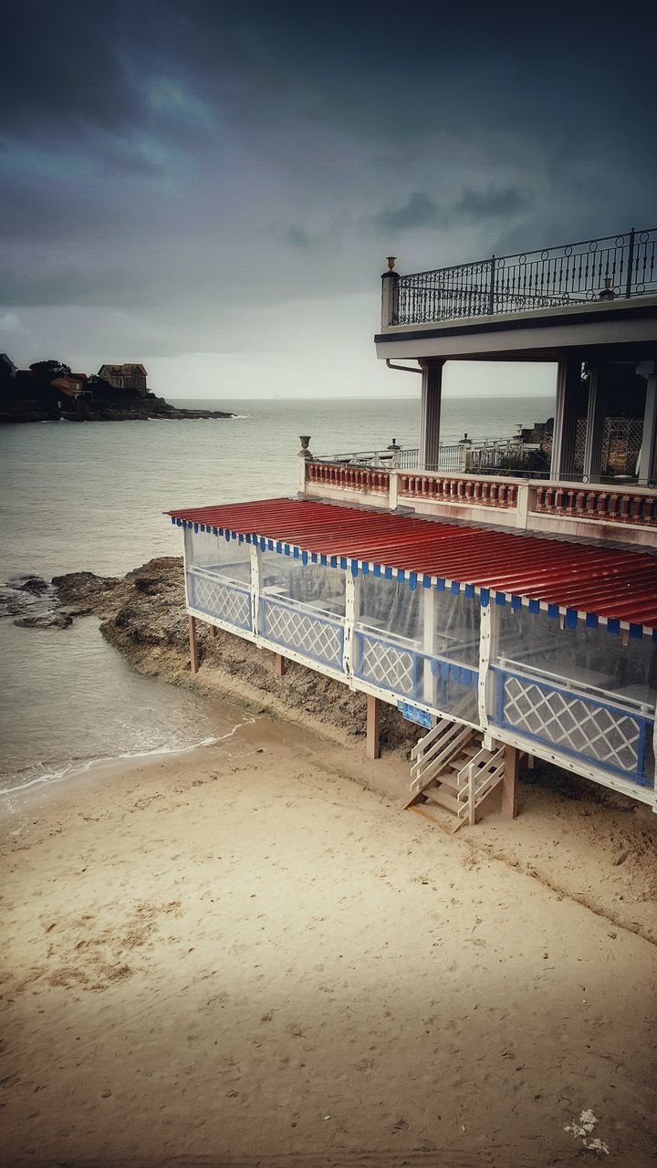 water, sky, sea, beach, cloud - sky, land, built structure, architecture, beauty in nature, nature, tranquility, scenics - nature, tranquil scene, sand, no people, horizon over water, horizon, railing, outdoors