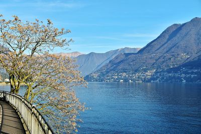 Scenic view of lake and mountains against blue sky