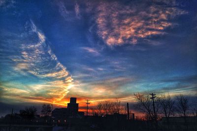 Silhouette of built structure at sunset