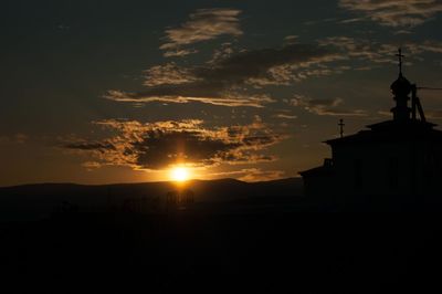 Silhouette building against sky during sunset