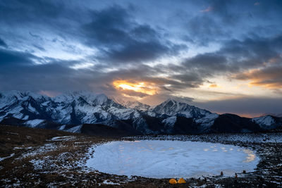 Scenic view of snowcapped mountains against sky during sunset