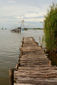 Pier over sea against sky