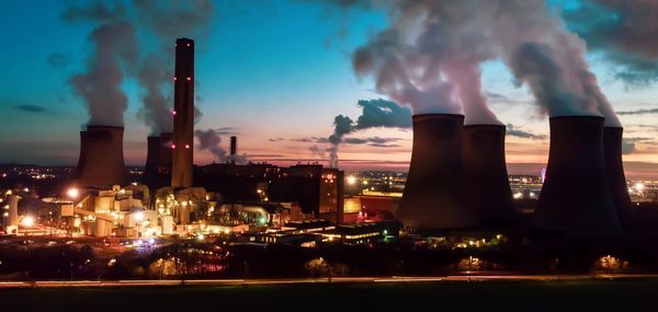 Smoke emitting from factory against sky at night