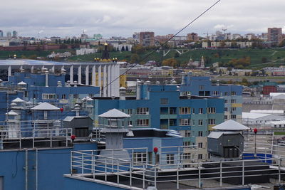 Buildings in city against cloudy sky