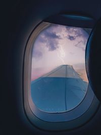 Cloudy sky seen through airplane window