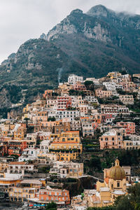 High angle view of townscape and mountains against sky