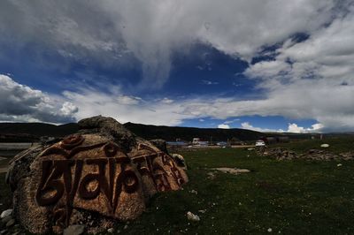 Scenic view of landscape against cloudy sky