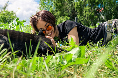 Portrait of young woman sitting on grassy field