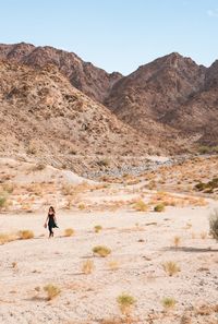 Rear view of a man walking on desert