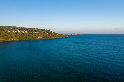 Scenic view of sea against clear blue sky