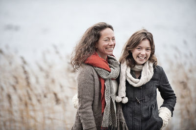 Mother and teenage daughter at water