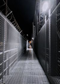 Illuminated passage on a bridge at night