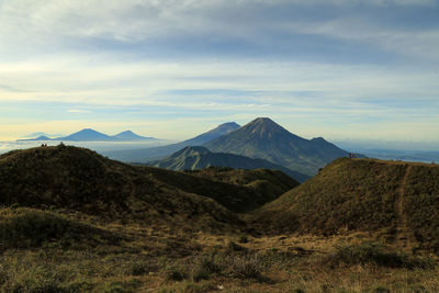 Scenic view of mountains against cloudy sky