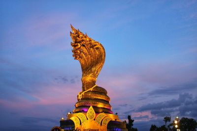 Low angle view of statue of temple against cloudy sky