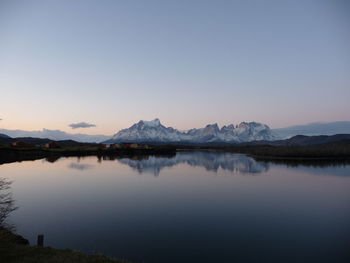 Scenic view of lake against clear sky during sunset