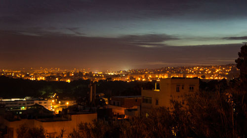 High angle view of illuminated cityscape at night