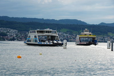 Boats in sea against sky