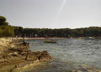 Boat sailing in sea against sky