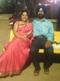 Portrait of a smiling couple sitting outdoors