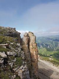 Rock formations on landscape against sky