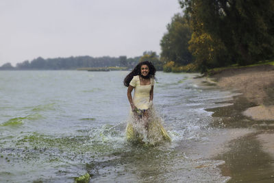 Portrait of woman standing in water