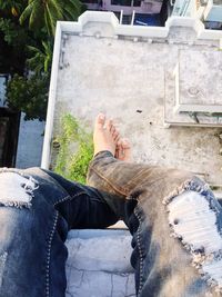 Low section of man sitting on building terrace