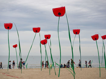 Decorations at beach against sky