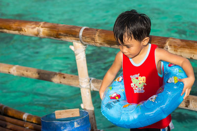 Boy looking at swimming pool