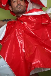 Close-up of young man standing in red flag