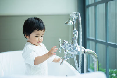 Side view of boy looking at camera