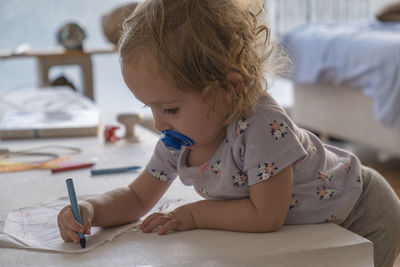 Boy looking away while sitting at home