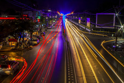 High angle view of light trails on road at night