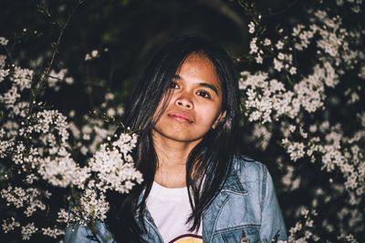 Portrait of beautiful woman standing by plants