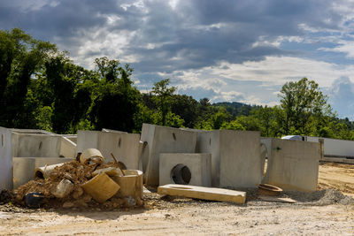 Abandoned stack on field against sky