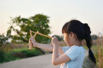 Side view of woman holding girl