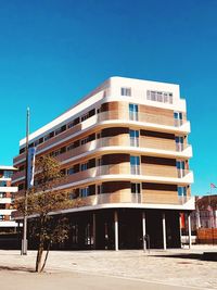 Low angle view of building against clear blue sky