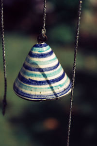 Close-up of rope tied on metal chain at playground