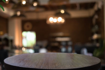 Close-up of illuminated lighting equipment on table in restaurant