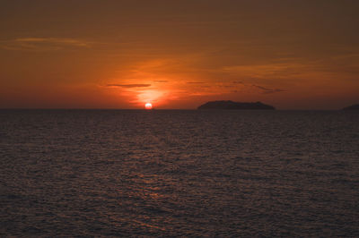 Scenic view of sea against orange sky