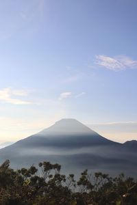 Scenic view of mountains against cloudy sky