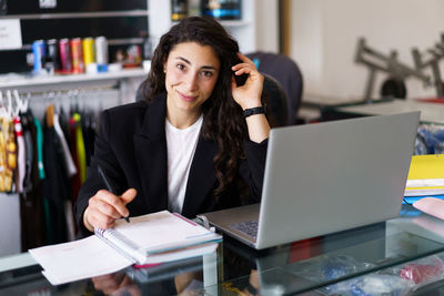 Portrait of smiling gym receptionist at desk