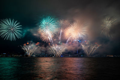 Low angle view of firework display at night